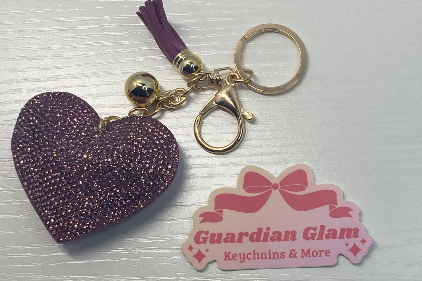 Purple Heart-shaped rhinestone 
Gold keychain with tassel