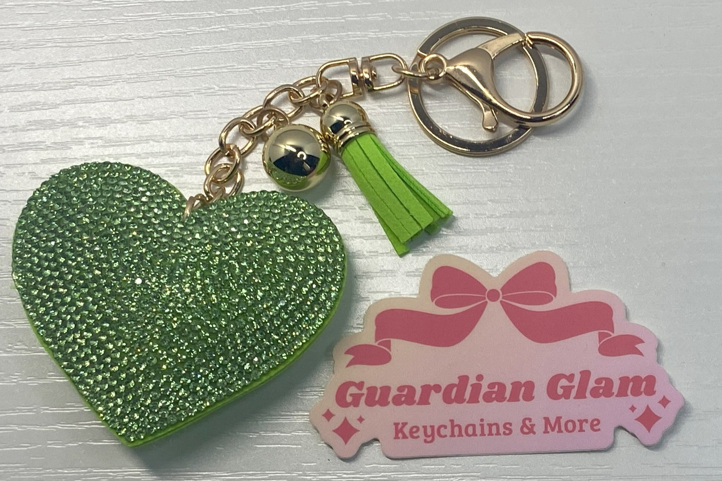 Green Heart-shaped rhinestone  
Gold keychain with tassel