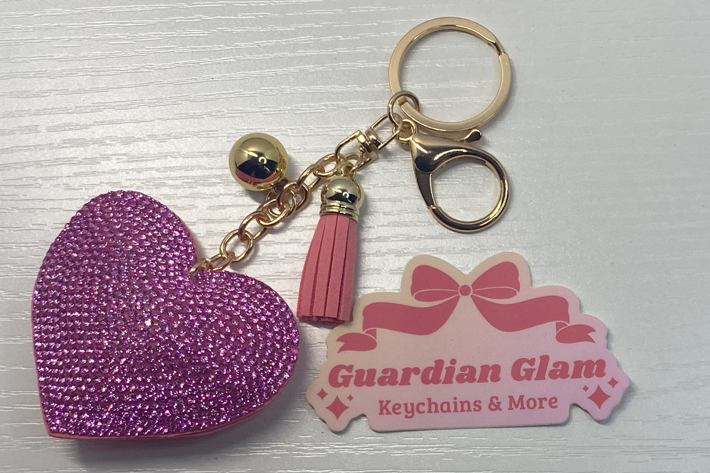 Light Pink Heart-shaped rhinestone  
Gold keychain with tassel