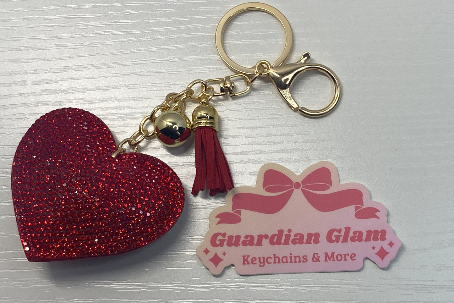 Red Heart-shaped rhinestone  
Gold keychain with tassel
